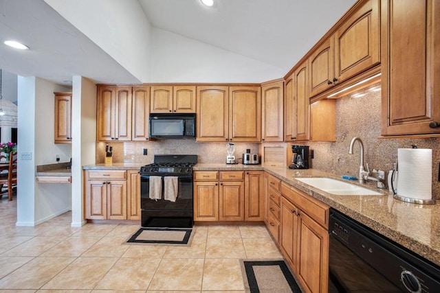 kitchen featuring light stone countertops, sink, vaulted ceiling, light tile patterned floors, and black appliances