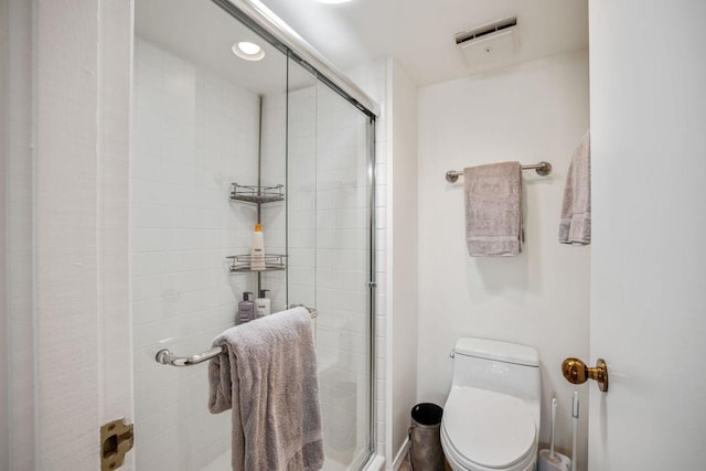 bathroom featuring toilet and walk in shower