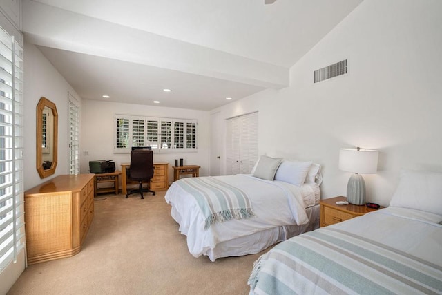 carpeted bedroom featuring a closet and lofted ceiling