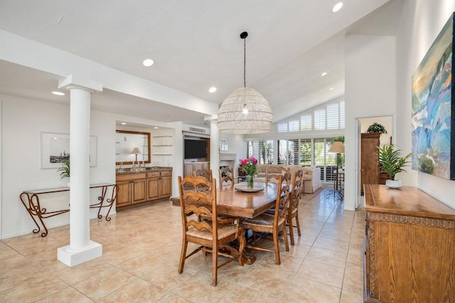 tiled dining space featuring vaulted ceiling and ornate columns