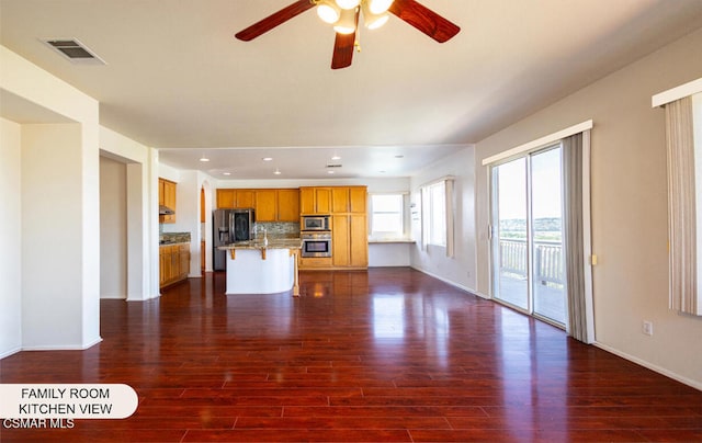 unfurnished living room with ceiling fan and dark hardwood / wood-style flooring