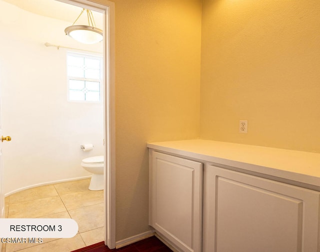 bathroom with tile patterned flooring and toilet