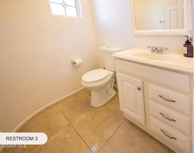 bathroom featuring tile patterned floors, vanity, and toilet