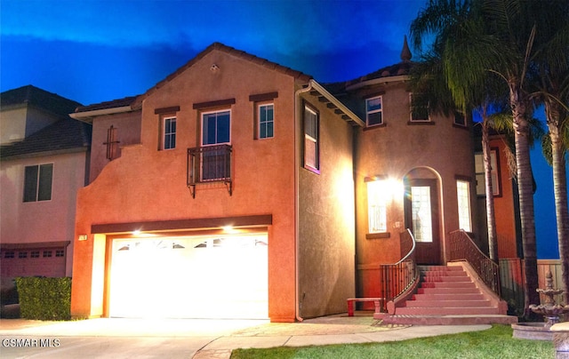 mediterranean / spanish-style house with a garage