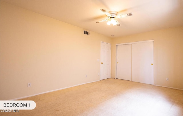 unfurnished bedroom with carpet, ceiling fan, and a closet