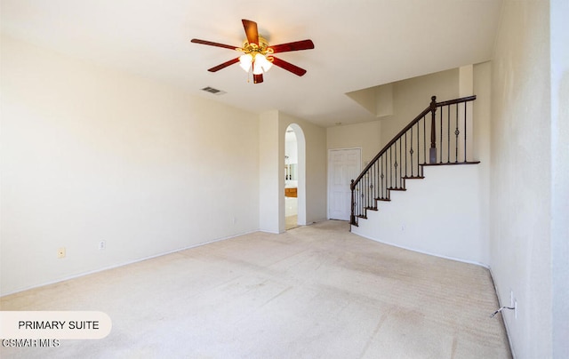 unfurnished living room with ceiling fan and light carpet