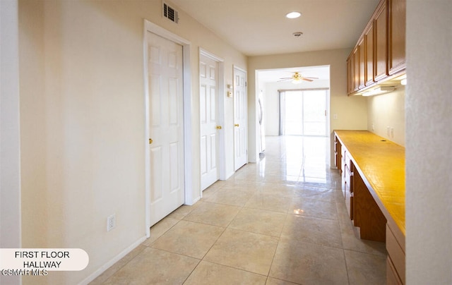 hall featuring light tile patterned floors