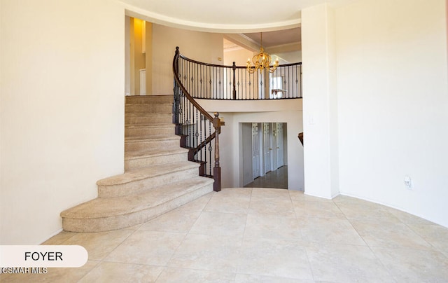 staircase with tile patterned floors and a chandelier