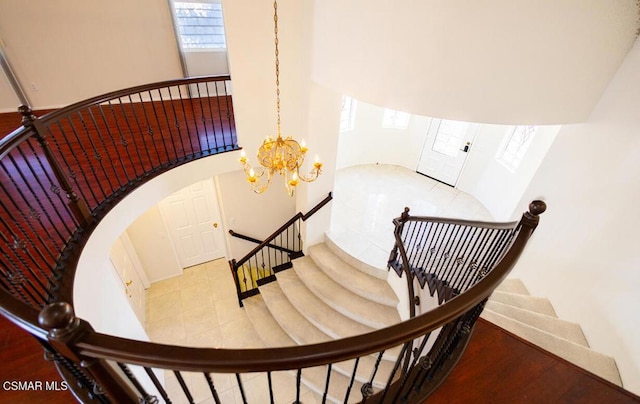 staircase featuring an inviting chandelier