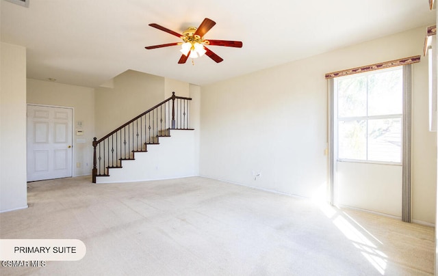 unfurnished living room with ceiling fan and light colored carpet