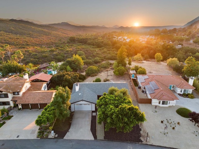 aerial view at dusk featuring a mountain view