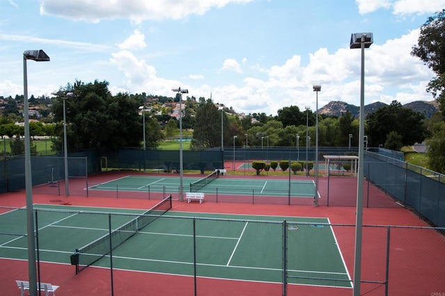 view of tennis court featuring a mountain view and basketball court