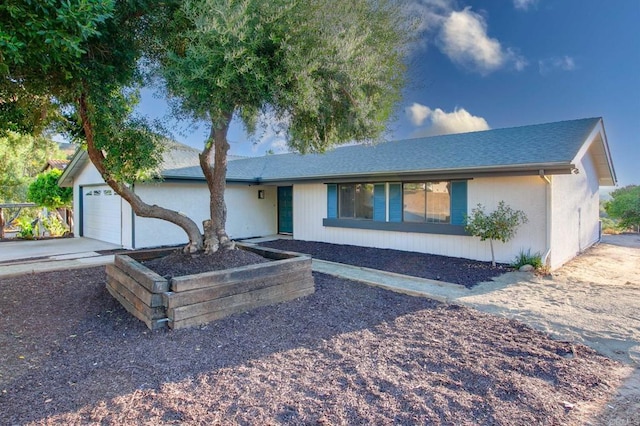 ranch-style home featuring a garage