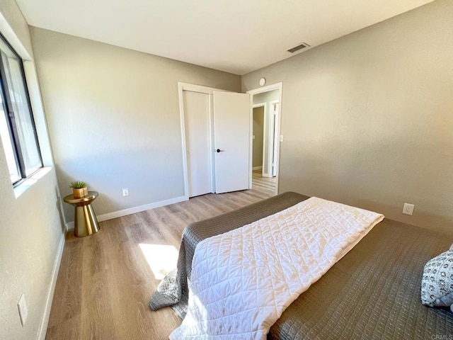 bedroom featuring hardwood / wood-style floors and a closet