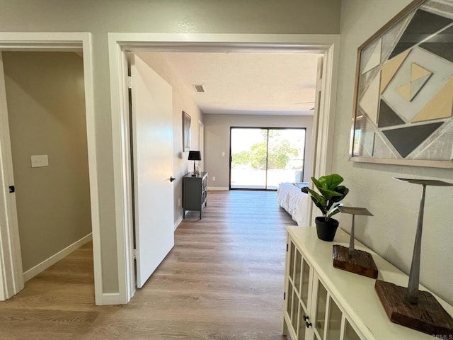 hall with light hardwood / wood-style floors