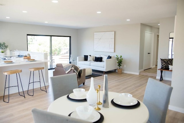 dining space with light wood-type flooring