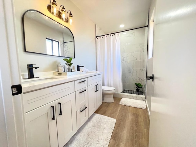 bathroom with vanity, toilet, hardwood / wood-style floors, and a shower with shower curtain