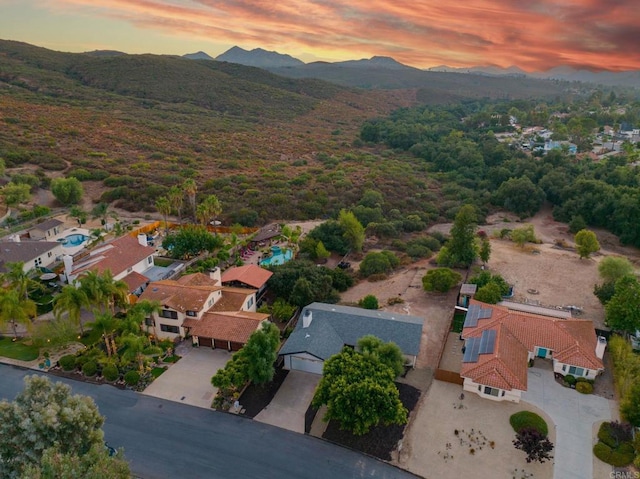 aerial view at dusk featuring a mountain view