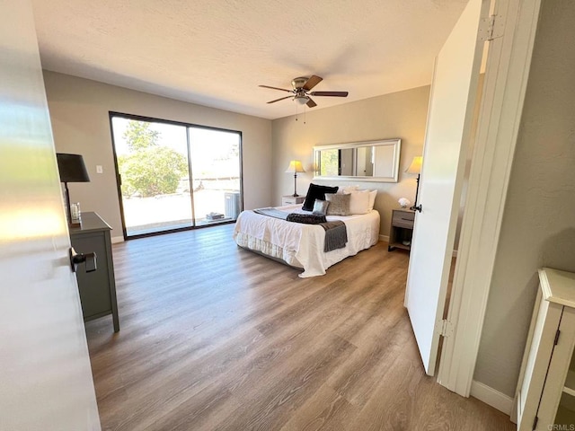 bedroom with access to exterior, ceiling fan, and light wood-type flooring