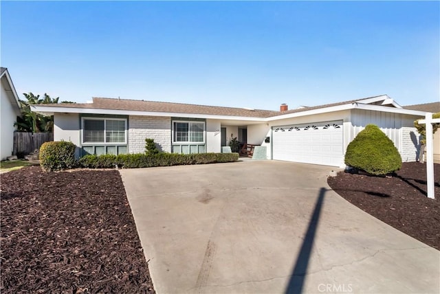 ranch-style house featuring driveway, brick siding, an attached garage, and fence