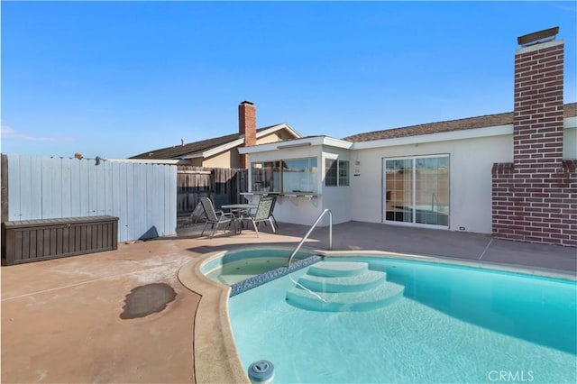 view of swimming pool with a fenced in pool, fence, and a patio