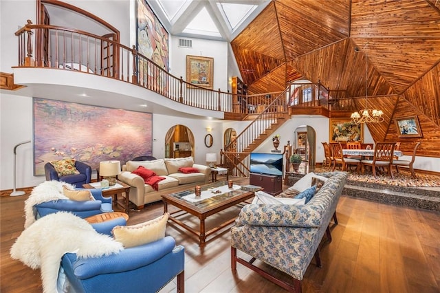 160 Yosemite Dr, Big Bear City, CA 92314 - living area featuring a towering ceiling, stairway, arched walkways, wood finished floors, and baseboards
