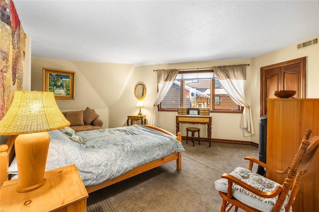 carpeted bedroom featuring a textured ceiling