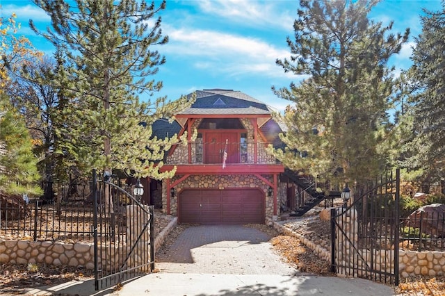 160 Yosemite Dr, Big Bear City, CA 92314 - view of front of home featuring stone siding, dirt driveway, an attached garage, and stairway
