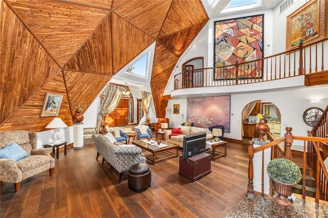 160 Yosemite Dr, Big Bear City, CA 92314 - living room featuring stairway, hardwood / wood-style floors, a towering ceiling, baseboards, and arched walkways