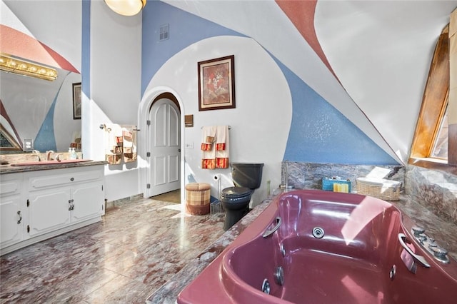 160 Yosemite Dr, Big Bear City, CA 92314 - full bath with vanity, marble tiled floors, a tub with jets, and vaulted ceiling
