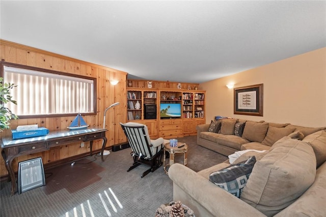 living room featuring carpet floors and wood walls