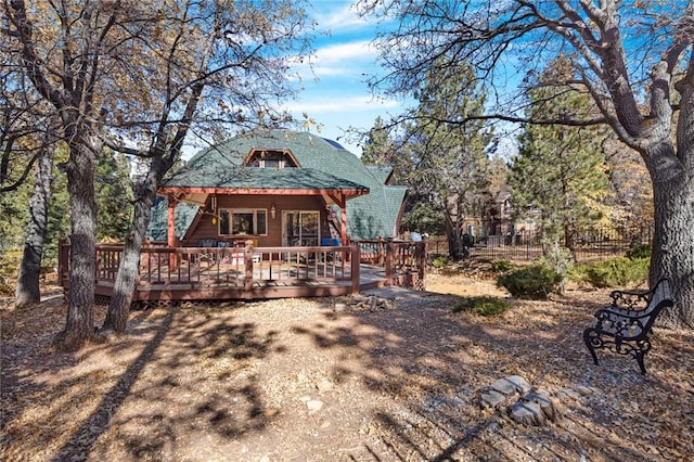 back of house featuring a wooden deck