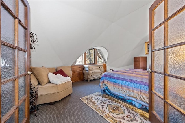 carpeted bedroom featuring lofted ceiling