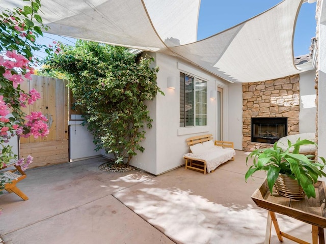 view of patio / terrace with an outdoor stone fireplace