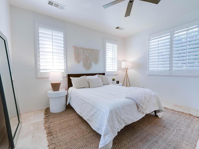 tiled bedroom featuring ceiling fan