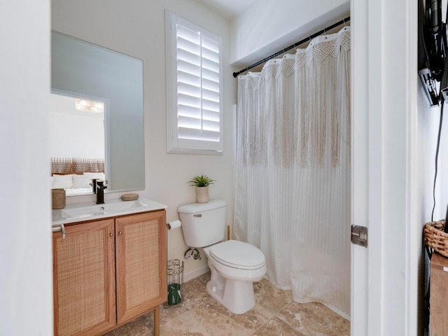 bathroom with vanity, toilet, and walk in shower