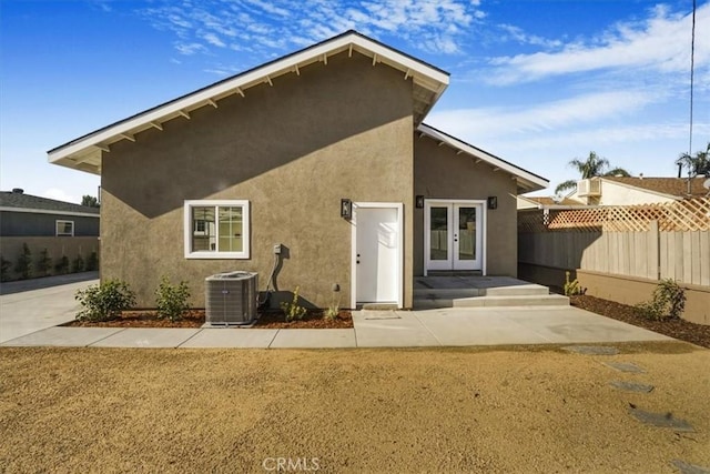 back of property featuring french doors and cooling unit