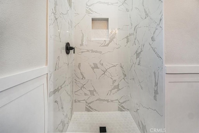 bathroom with a tile shower