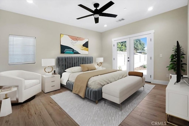 bedroom with access to exterior, ceiling fan, french doors, and light hardwood / wood-style flooring