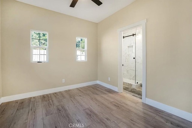 spare room featuring light hardwood / wood-style flooring and ceiling fan