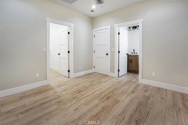 interior space featuring connected bathroom and light wood-type flooring