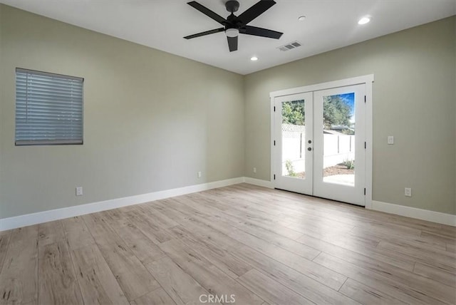 empty room with ceiling fan, french doors, and light hardwood / wood-style flooring