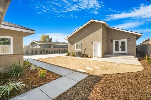 back of house with french doors and central AC unit