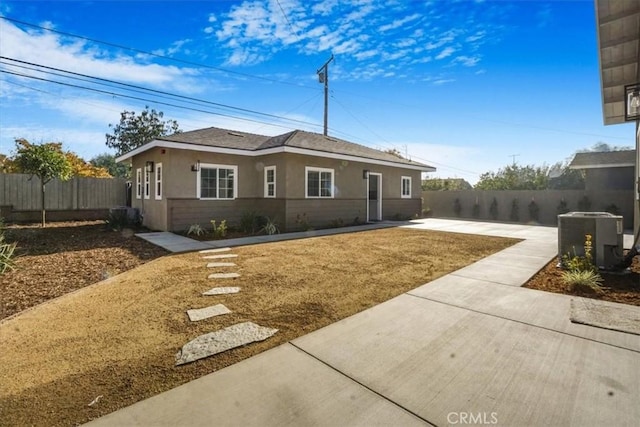 ranch-style house with a patio and cooling unit