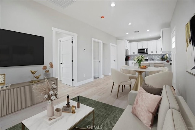 living room with light hardwood / wood-style floors