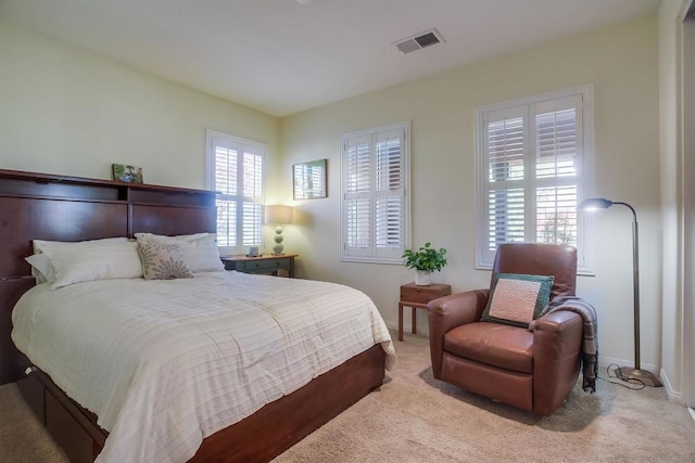 bedroom featuring light carpet