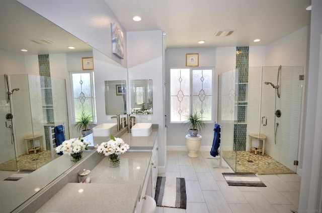 bathroom with tile patterned flooring, vanity, and a shower with door