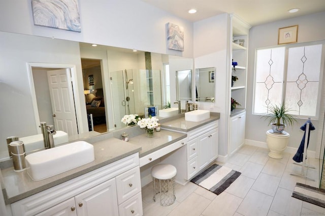 bathroom with tile patterned flooring, vanity, and a shower with shower door