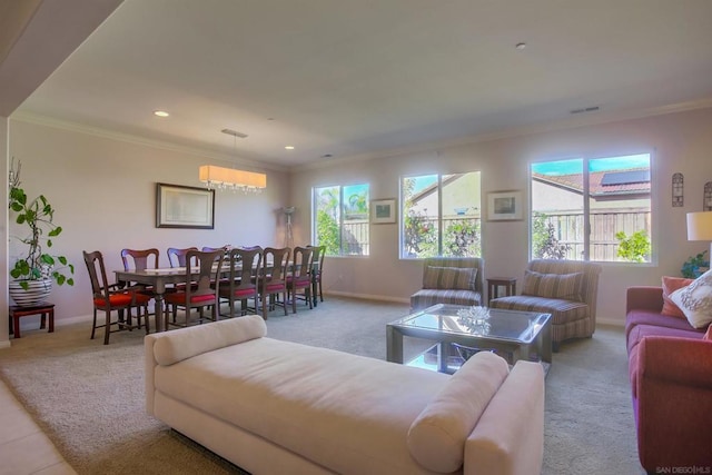 living room featuring light carpet, ornamental molding, a healthy amount of sunlight, and a notable chandelier