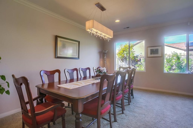 carpeted dining space featuring a notable chandelier and ornamental molding